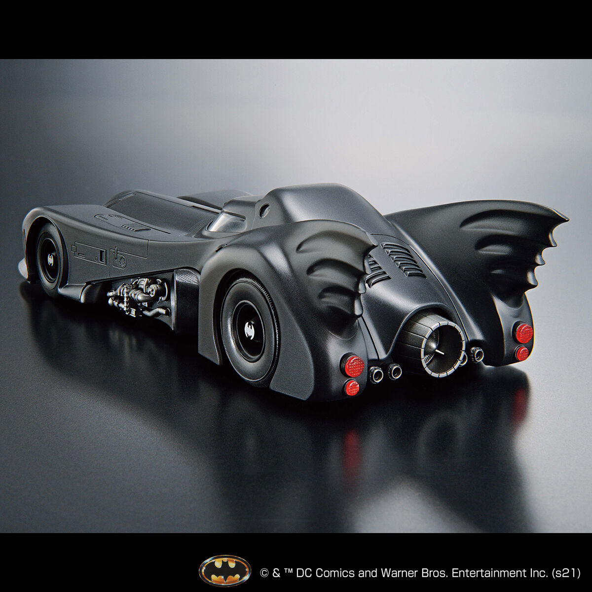 Image alt text: Batman - 1/35 Scale Batmobile (Batman Ver.) - Model Kit, intricately sculpted parts, slideable roof section, meticulously reproduced cockpit interior and mechanical details, deployment of machine guns and rocket anchors, Nippon Figures.
