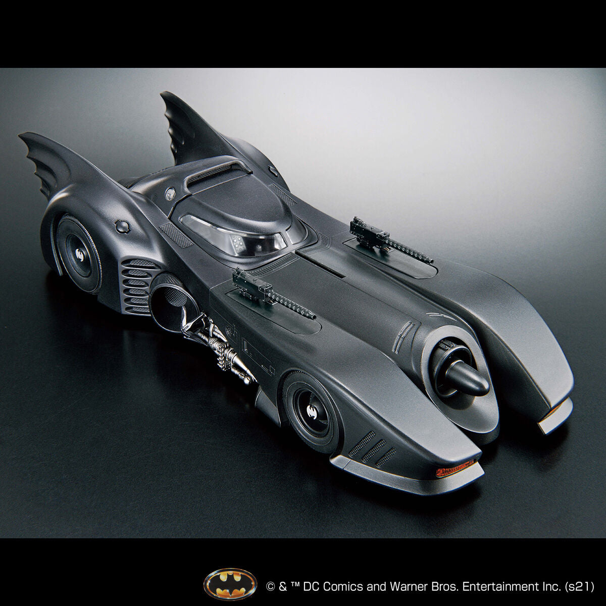 Image alt text: Batman - 1/35 Scale Batmobile (Batman Ver.) - Model Kit, intricately sculpted parts, slideable roof section, meticulously reproduced cockpit interior and mechanical details, deployment of machine guns and rocket anchors, Nippon Figures.