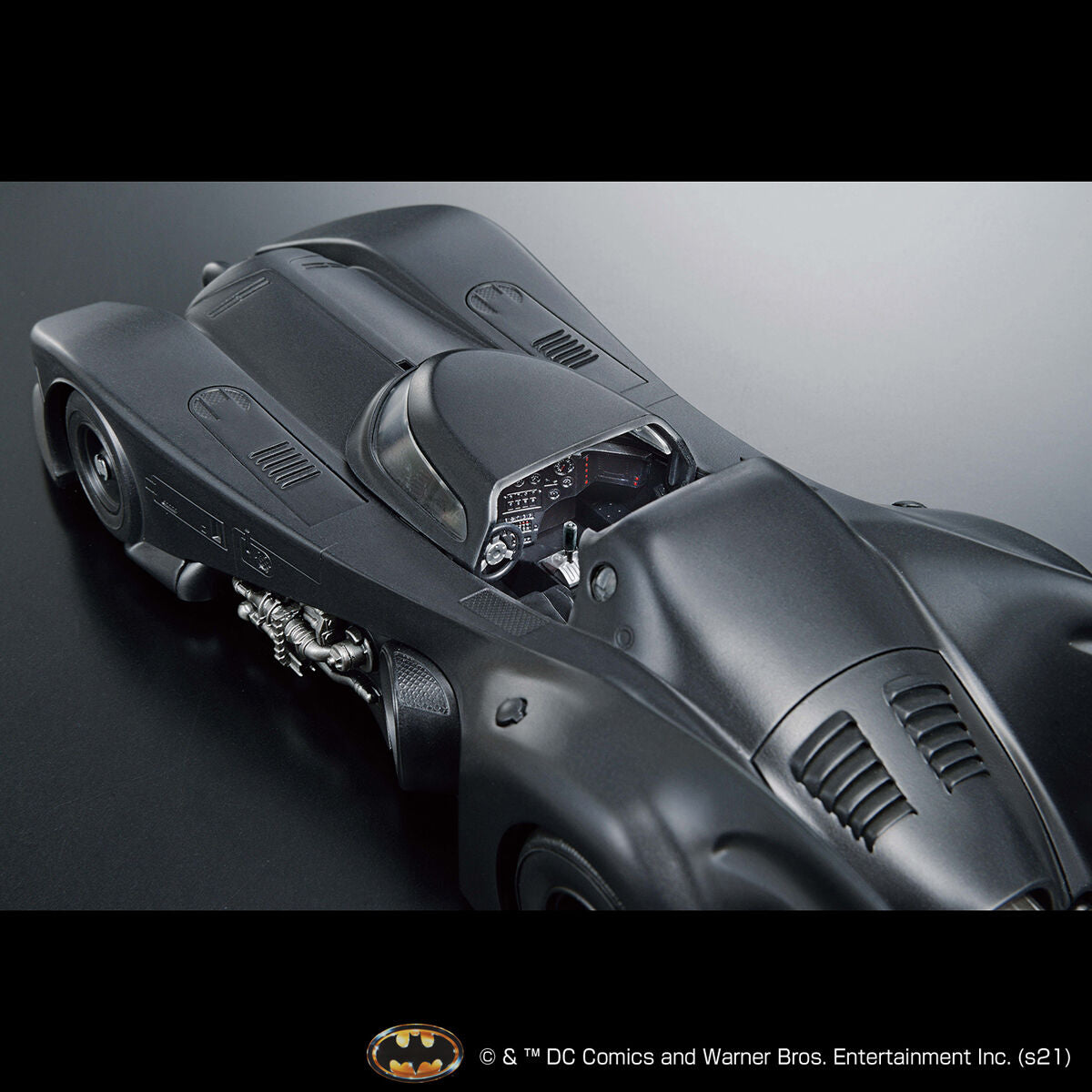 Image alt text: Batman - 1/35 Scale Batmobile (Batman Ver.) - Model Kit, intricately sculpted parts, slideable roof section, meticulously reproduced cockpit interior and mechanical details, deployment of machine guns and rocket anchors, Nippon Figures.