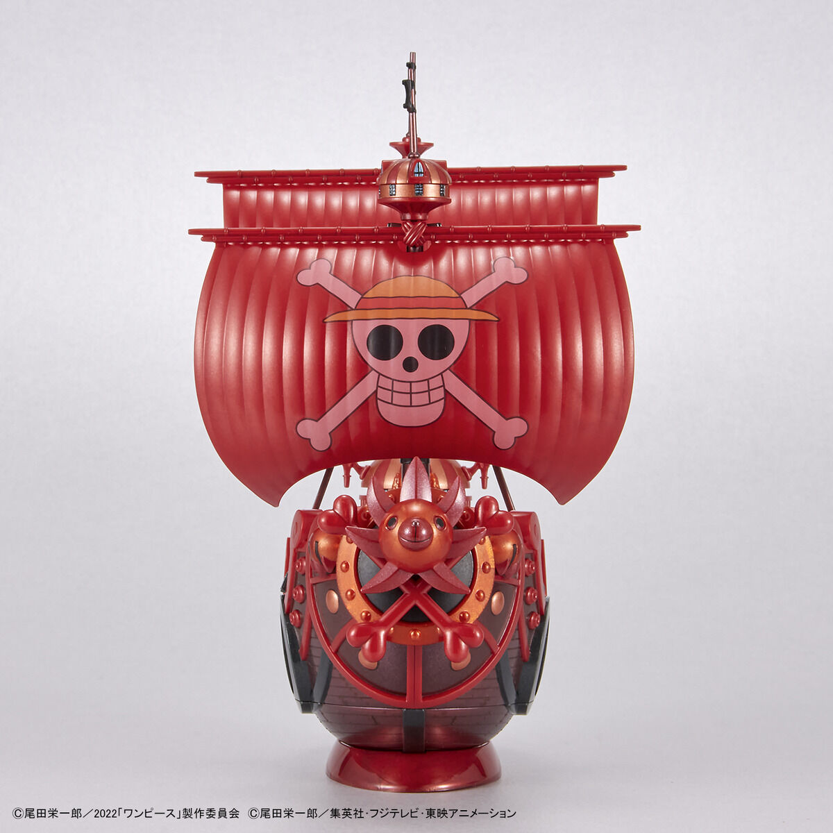 One Piece - Thousand Sunny - RED FILM Special - Grand Ship Collection Model Kit (Bandai), Metallic red color scheme inspired by the film "ONE PIECE FILM RED", includes character plates of the Straw Hat Pirates in movie costumes, display base and sea surface effect included, from Nippon Figures.