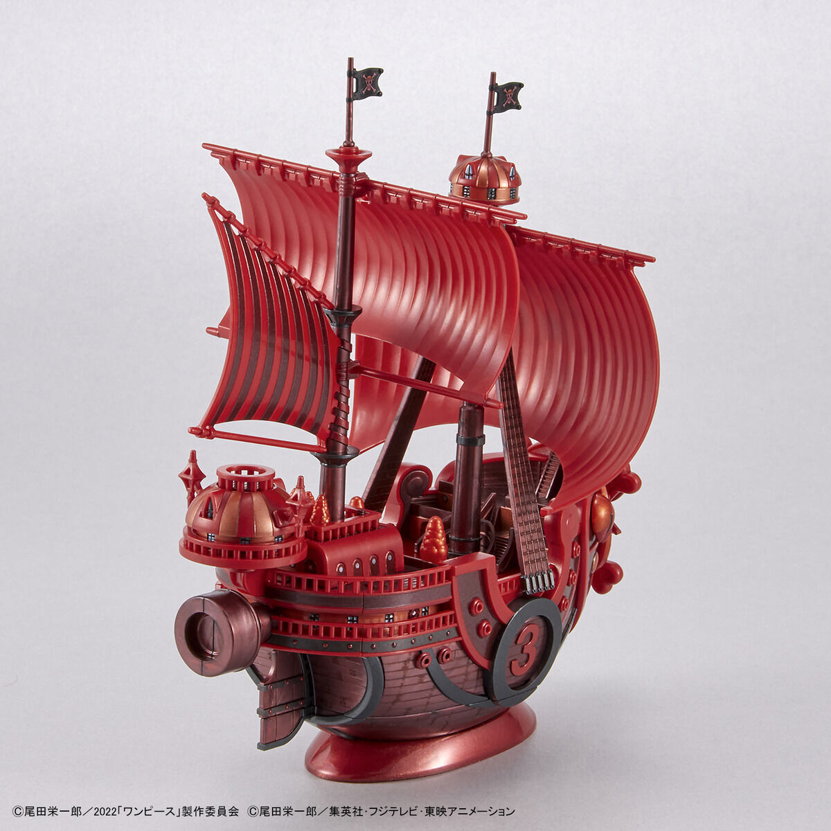 One Piece - Thousand Sunny - RED FILM Special - Grand Ship Collection Model Kit (Bandai), Metallic red color scheme inspired by the film "ONE PIECE FILM RED", includes character plates of the Straw Hat Pirates in movie costumes, display base and sea surface effect included, from Nippon Figures.