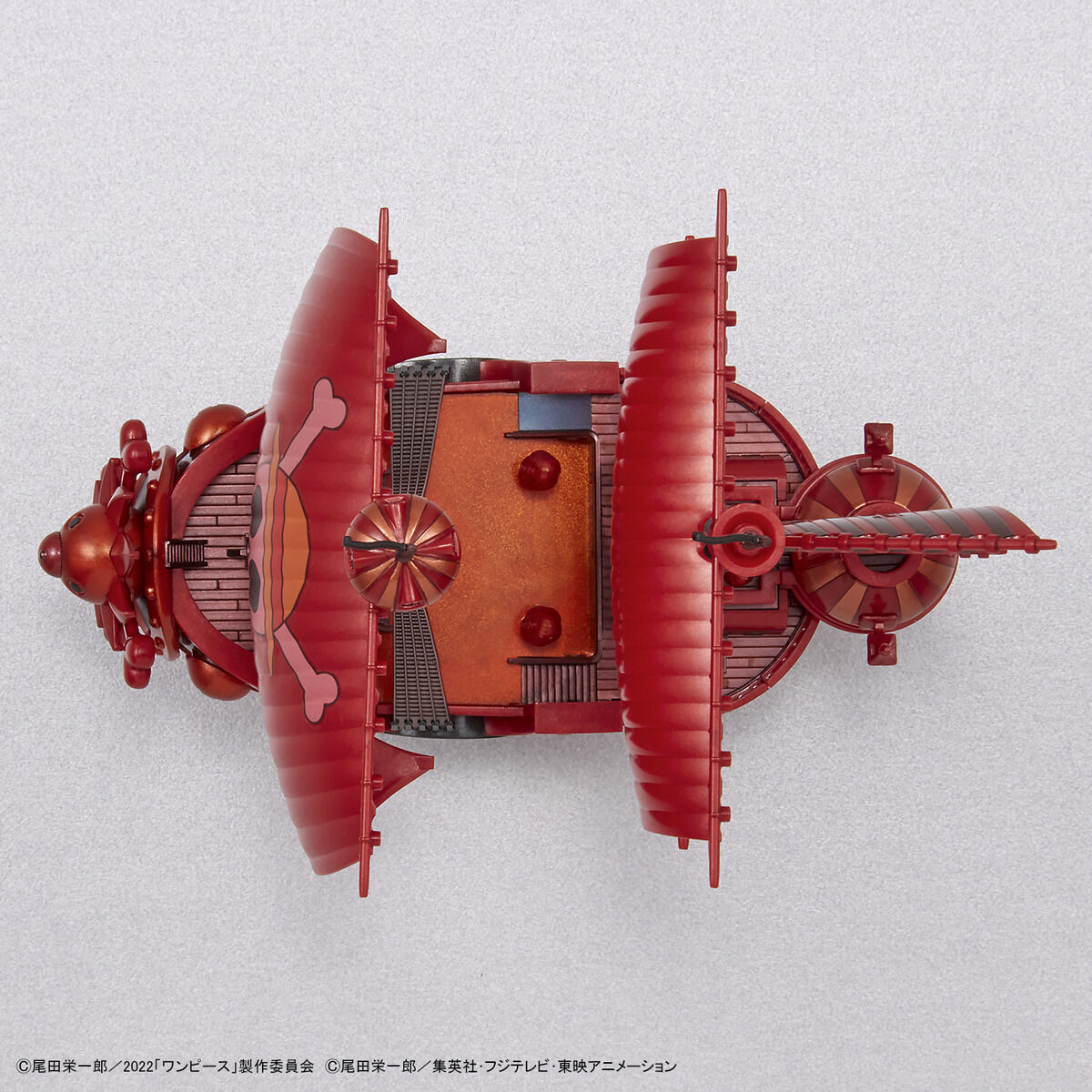 One Piece - Thousand Sunny - RED FILM Special - Grand Ship Collection Model Kit (Bandai), Metallic red color scheme inspired by the film "ONE PIECE FILM RED", includes character plates of the Straw Hat Pirates in movie costumes, display base and sea surface effect included, from Nippon Figures.