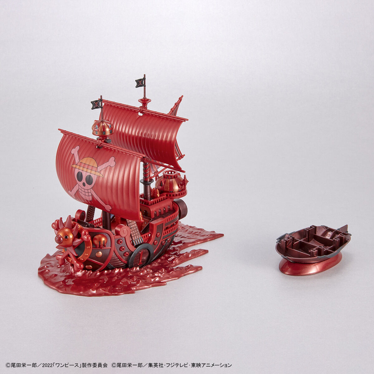 One Piece - Thousand Sunny - RED FILM Special - Grand Ship Collection Model Kit (Bandai), Metallic red color scheme inspired by the film "ONE PIECE FILM RED", includes character plates of the Straw Hat Pirates in movie costumes, display base and sea surface effect included, from Nippon Figures.