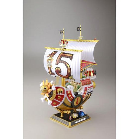 One Piece - Thousand Sunny (15th Year Anniversary) - Grand Ship Collection Model Kit, commemorating the 15th anniversary of the One Piece anime, includes character plate and sea surface effect, by Nippon Figures.